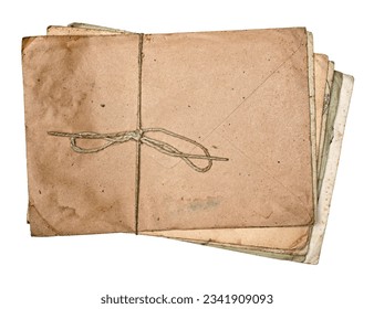 Stack of yellowed and dirty old antique letters and envelopes, tied with string isolated on white background.