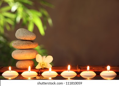 Stack of zen stones and aromatic candles on table,Zen concept. - Powered by Shutterstock