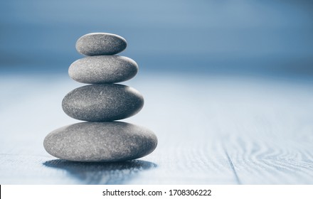Stack of Zen Stones on blue background.