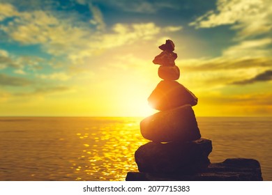 Stack Of Zen Stones On Sunset Beach