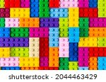 stackable plastic toy bricks in top view.  Colorful texture childhood education and development concept background.