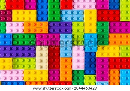 stackable plastic toy bricks in top view.  Colorful texture childhood education and development concept background.