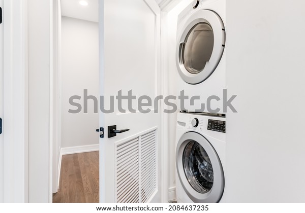 Stackable White Front Load Washer and Dryer in\
White Closet