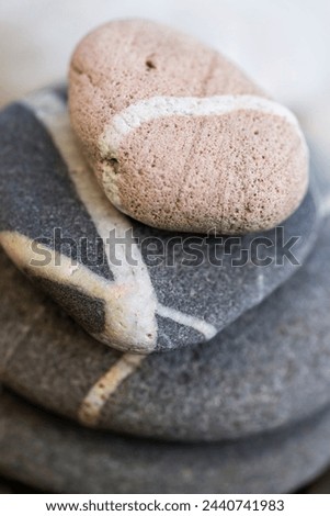 Stacked beach pebbles with white veins, macro closeup.