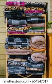 Stacked blankets in a retro cabinet