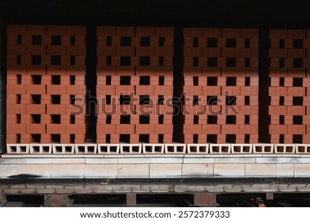Stacked bricks in drying process at brick production facility move to oven