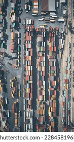 Stacked cargo containers top down aerial view. Containers at logistics terminal. Cargo container outdoor warehouse