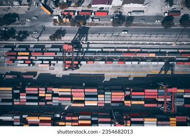 Stacked cargo containers top down aerial view. Containers at logistics terminal. Cargo container outdoor warehouse