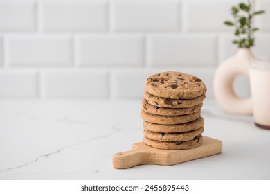 Stacked chocolate chip cookies on a wooden board - Powered by Shutterstock