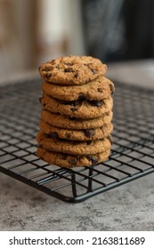 stacked and close-up view of chocolate cookies on a cooling rack. Selective focus. Blurred background.