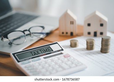 Stacked Of Coins With Calculator,House Model,tax Form,glasses And Notebook,Income Tax Raise Concept.