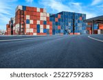 Stacked containers and empty asphalt road at the port