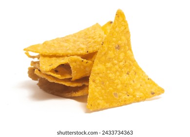 Stacked of crispy corn tortilla nachos chips isolated on white background clipping path