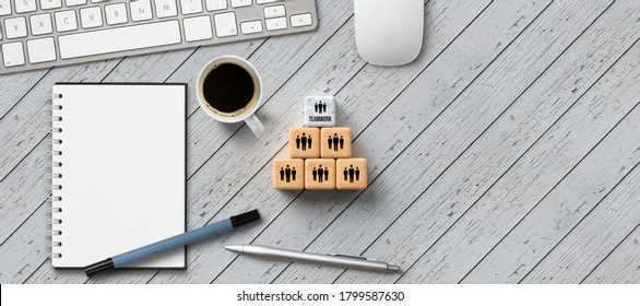 Stacked Cubes With Message TEAM And Team Icons With Office Items On Wooden Background