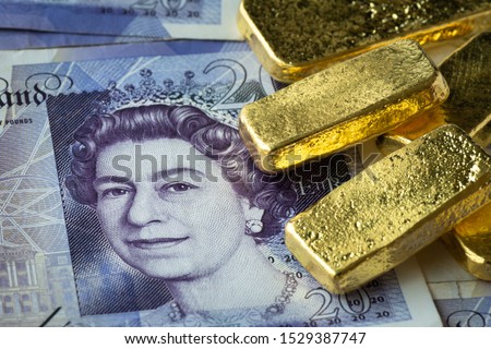 Stacked of gold bar on  banknote, GBP or pound with gold bar