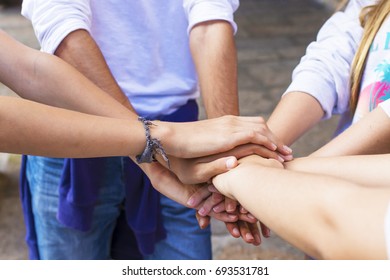 stacked hands, friendship, fellowship and team - Shutterstock ID 693531781
