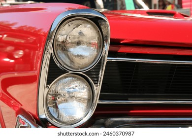 Stacked headlights on a classic red car. - Powered by Shutterstock