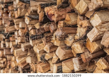 Stacked Hickory logs split for Barbeque.