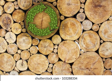 Stacked Logs with recycle symbol, concept