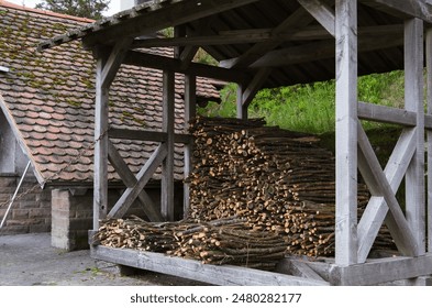 Stacked Logs Under Wooden Roof - Powered by Shutterstock