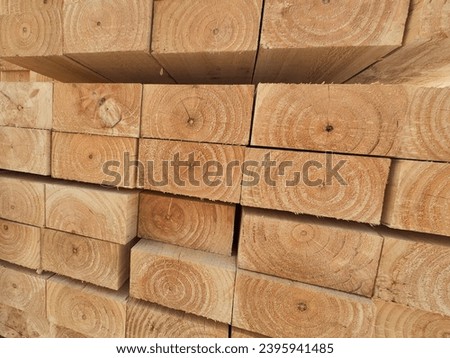 Stacked of lumber in timber logs for construction or industrial work. wooden building materials