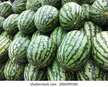 Stacked many big sweet green watermelons on the market


