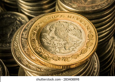 stacked-mexican-peso-coins-260nw-283408898.jpg