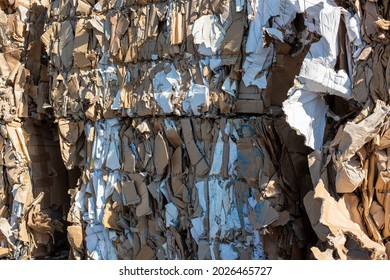 Stacked old waste paper in front of a recycling facility