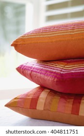 Stacked orange pillows at home