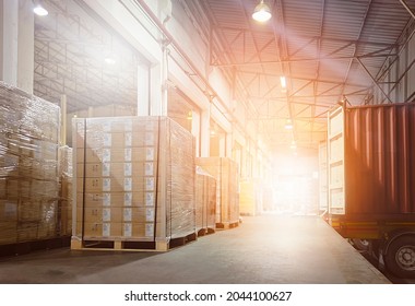 Stacked of Package Boxes on Pallets Loading with Shipping Cargo Container. Truck Parked Loading at Dock Warehouse. Delivery. Supply Chain. Warehouse Logistics. Cargo Freight Truck Transportation.	
