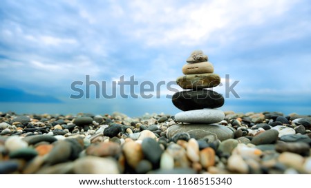 Stacked pebbles along the beach. This image is suitable for background use. It provides a feel of peacefulness, harmony, quietness and relaxation.