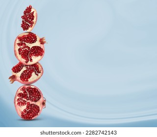 Stacked pieces of pomegranate on pale light blue gradient background, space for text - Shutterstock ID 2282742143