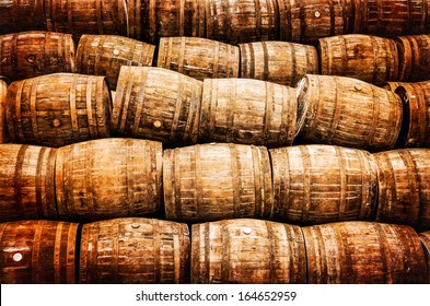 Stacked Pile Of Old Whisky And Wine Wooden Barrels In Vintage Style