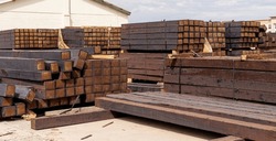 Stacked Piles Of New Railroad Ties Also Called Railway Sleepers With Anti-split Plates On The Ends