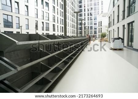 Stacked recycled flower boxes from plastic residual mix waste as the basis for a green wall. Basic construction of a vertical facade garden.