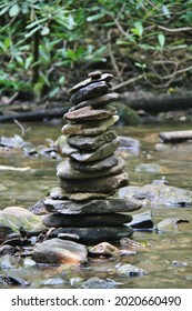 Stacked River Rocks In The Middle Of A Mountain Stream.