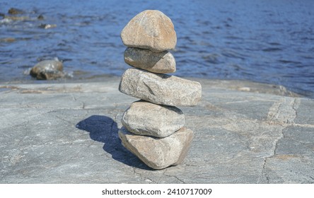 Stacked Rocks balancing, stacking with precision. Stone tower on the shore. 
