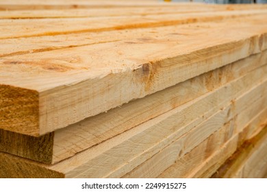 Stacked rough sawn timber planks ready for construction. - Shutterstock ID 2249915275
