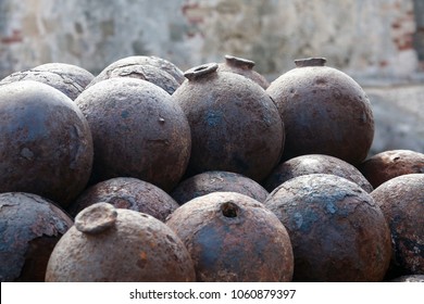 stacked rusty cannonballs forming interesting pattern, Castillo San Cristobal, San Juan, Puerto Rico, Caribbean
