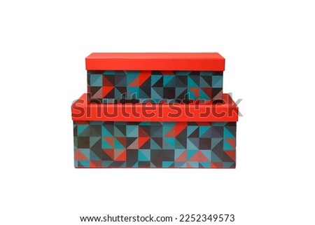 Stacked set of two rectangular gift boxes with vibrant red lids and colorful geometric triangle pattern, isolated on white background. Blank cardboard packaging mockup.