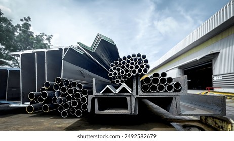 Stacked steel pipes with Construction steel, black pipe,Metal tubes, Angle steel, flat pipe, square pipe, close-up monochrome photo with selective focus,Stack of Many Pipes at the Construction Site - Powered by Shutterstock