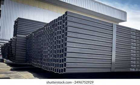 Stacked steel pipes with Construction steel, black pipe,Metal tubes, Angle steel, flat pipe, square pipe, close-up monochrome photo with selective focus,Stack of Many Pipes at the Construction Site - Powered by Shutterstock