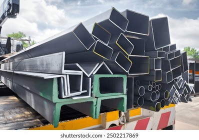 Stacked steel pipes with Construction steel, black pipe,Metal tubes, Angle steel, flat pipe, square pipe, close-up monochrome photo with selective focus,Stack of Many Pipes at the Construction Site - Powered by Shutterstock