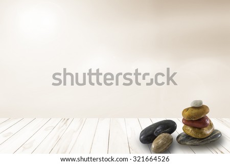 Stacked of stone on Wood floor texture with blur warm summer background to health on the porch a white. Natural spa concept the blurred backgrounds.