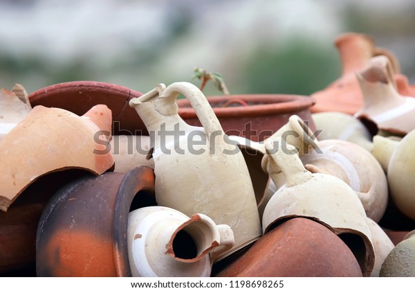 stacked together broken clay\
pots