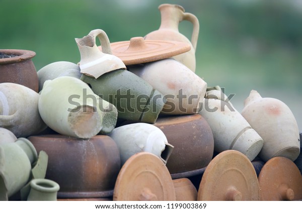 stacked together broken clay\
pots
