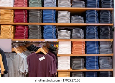 Stacked Of A Lot Of  T-shirts On Shelf