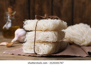 Stacked Uncooked Rice Noodles On Wooden Table