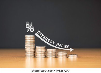 STACKED US QUARTER COINS ON WOODEN TABLE WITH WHITE ILLUSTRATION SHOWS DECREASING OF INTEREST RATES / FINANCIAL CONCEPT - Shutterstock ID 795267277