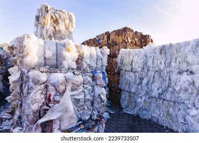 stacked waste paper and plastic waste collected for recycling - Shutterstock ID 2239733507